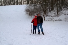Couple walking by sled hill